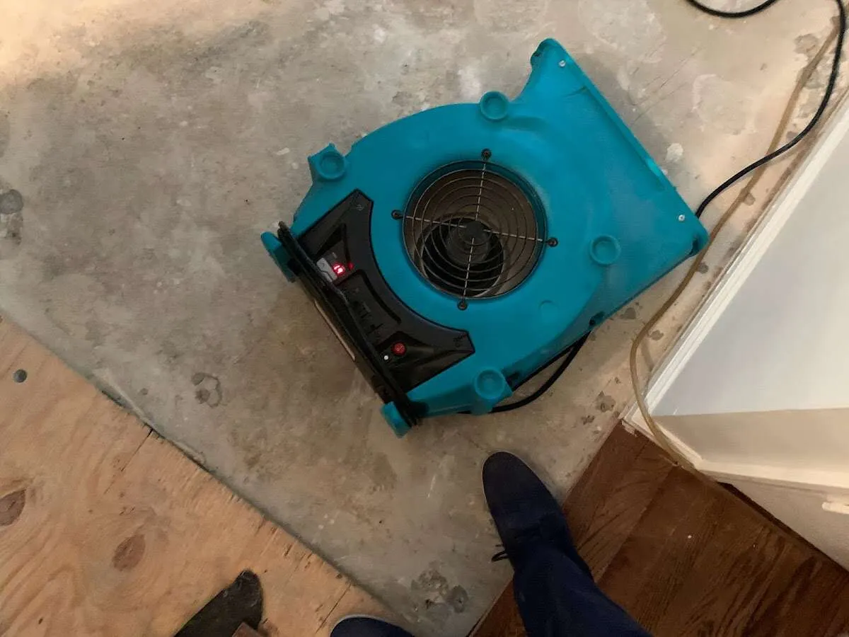 Air mover drying subfloor during Commercial Water Damage Restoration in Laguna Woods
